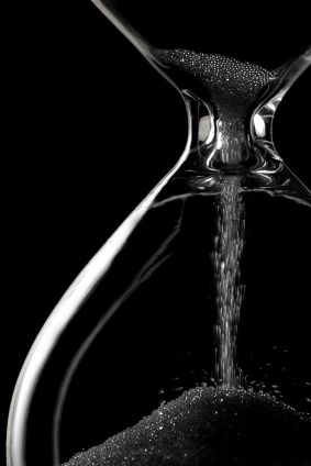 time is slipping - hourglass on black